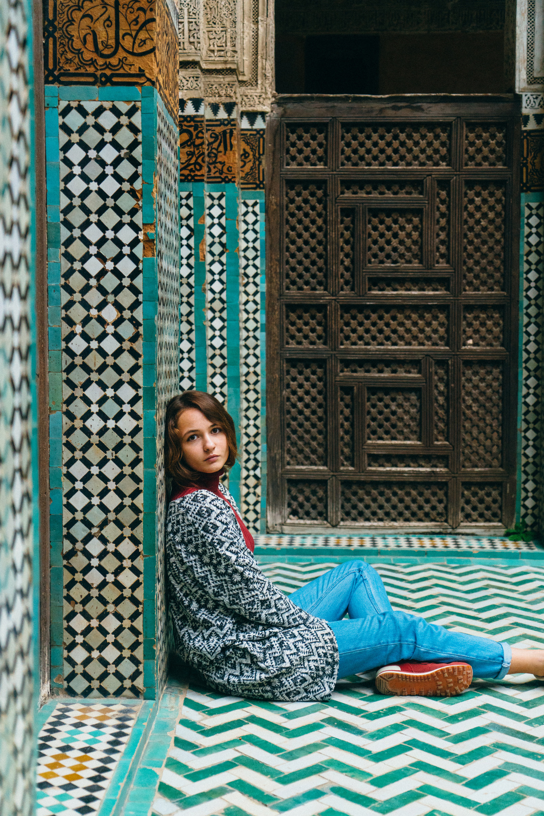 Woman sitting inside riad in Morocco